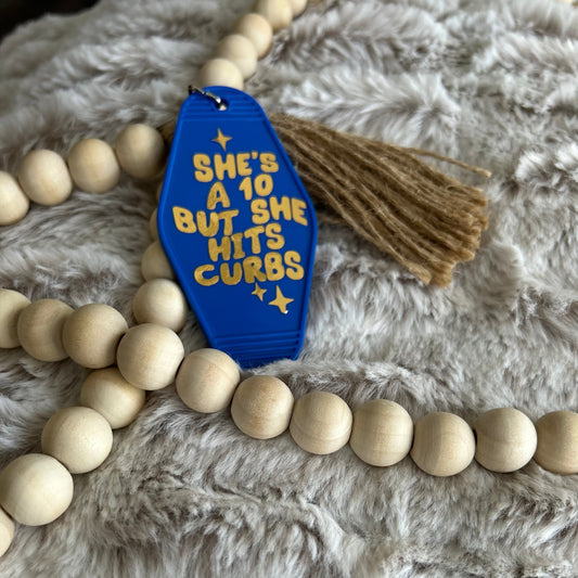 Blue vintage retro style keychain that says She's a 10 but hits curbs