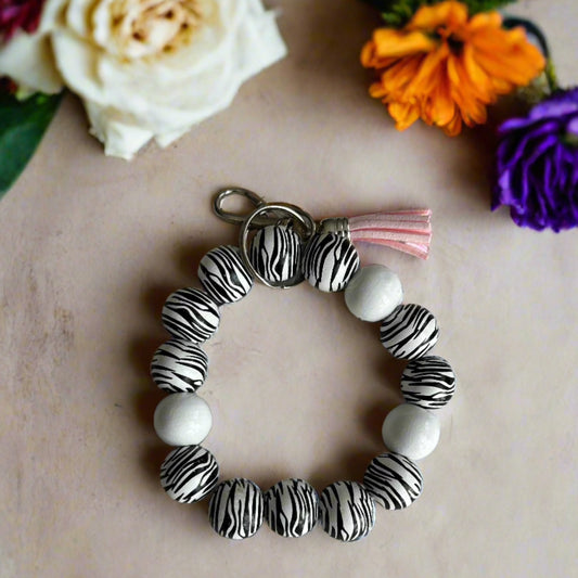 wooden bead wristlet keychain with pink tassle