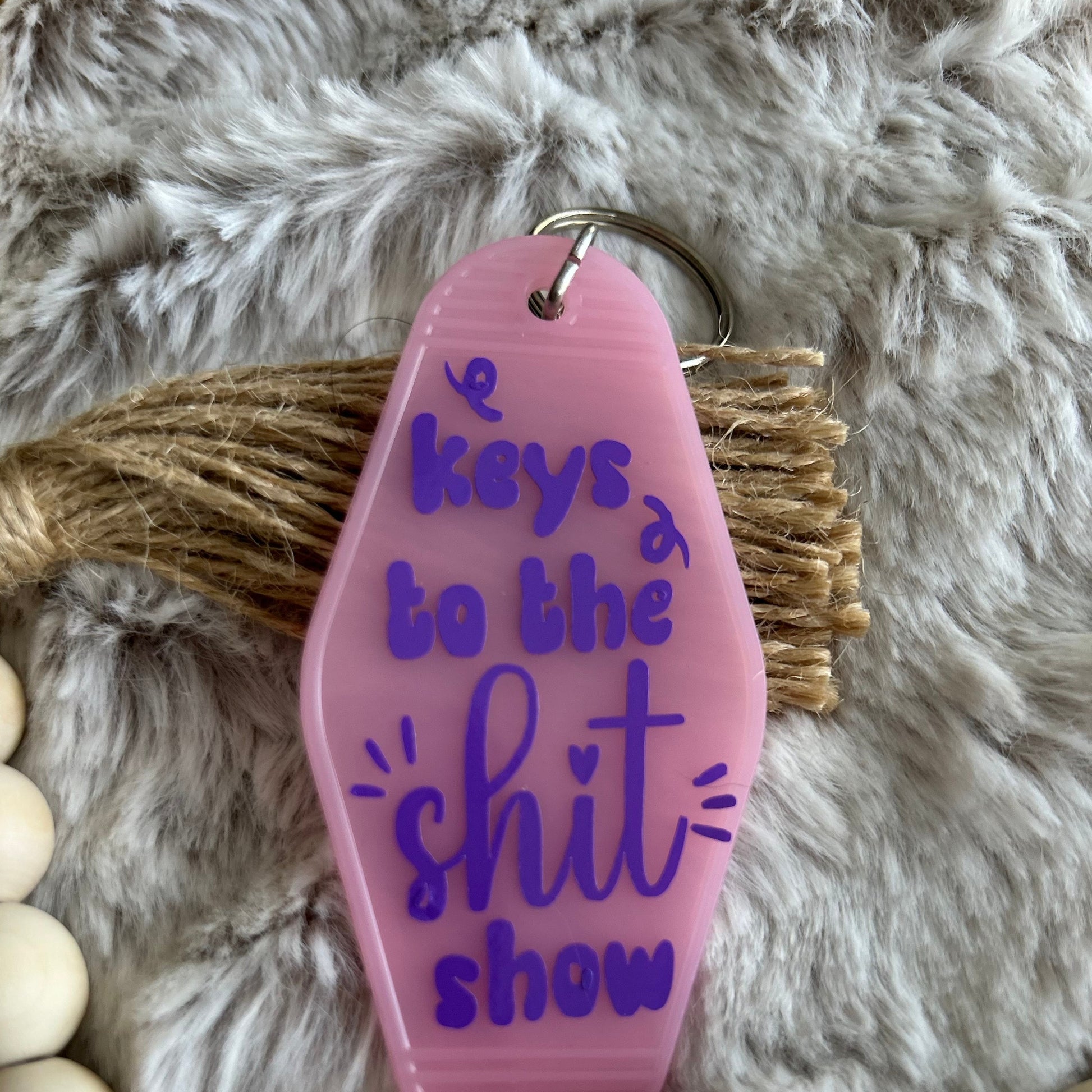 Retro style Motel Keychain. Pink keychain with purple lettering