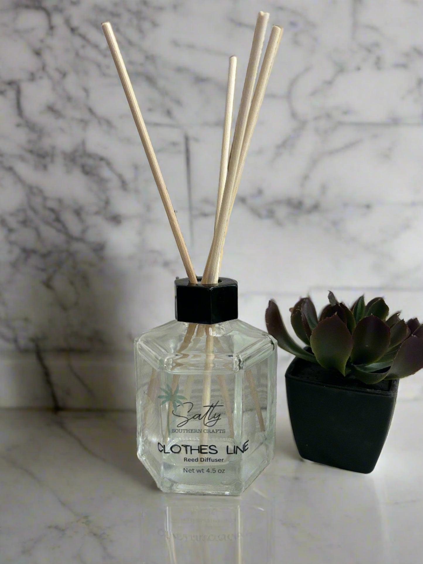 Reed diffuser with reeds in the scent clothesline