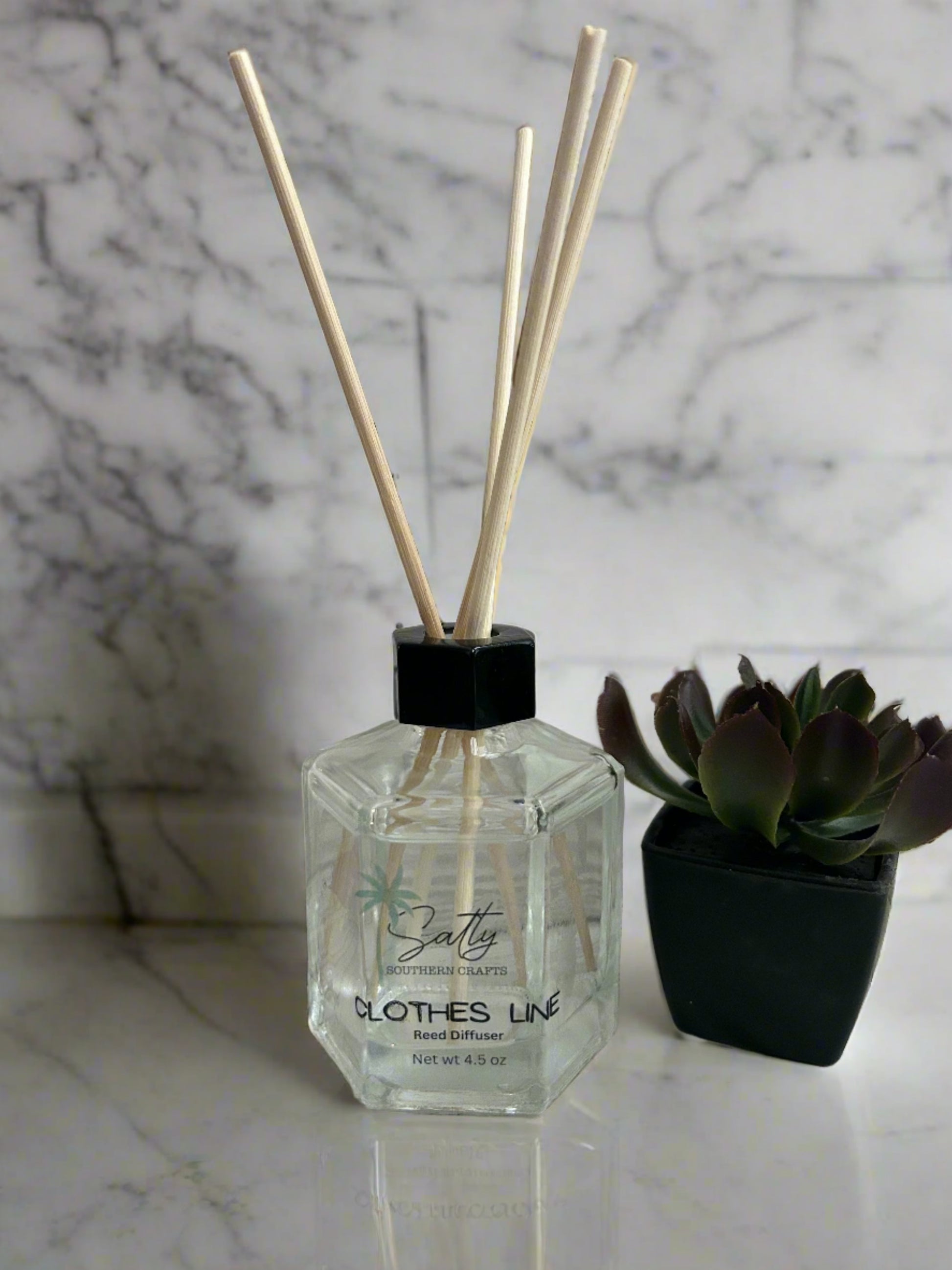 Reed diffuser with reeds in the scent clothesline