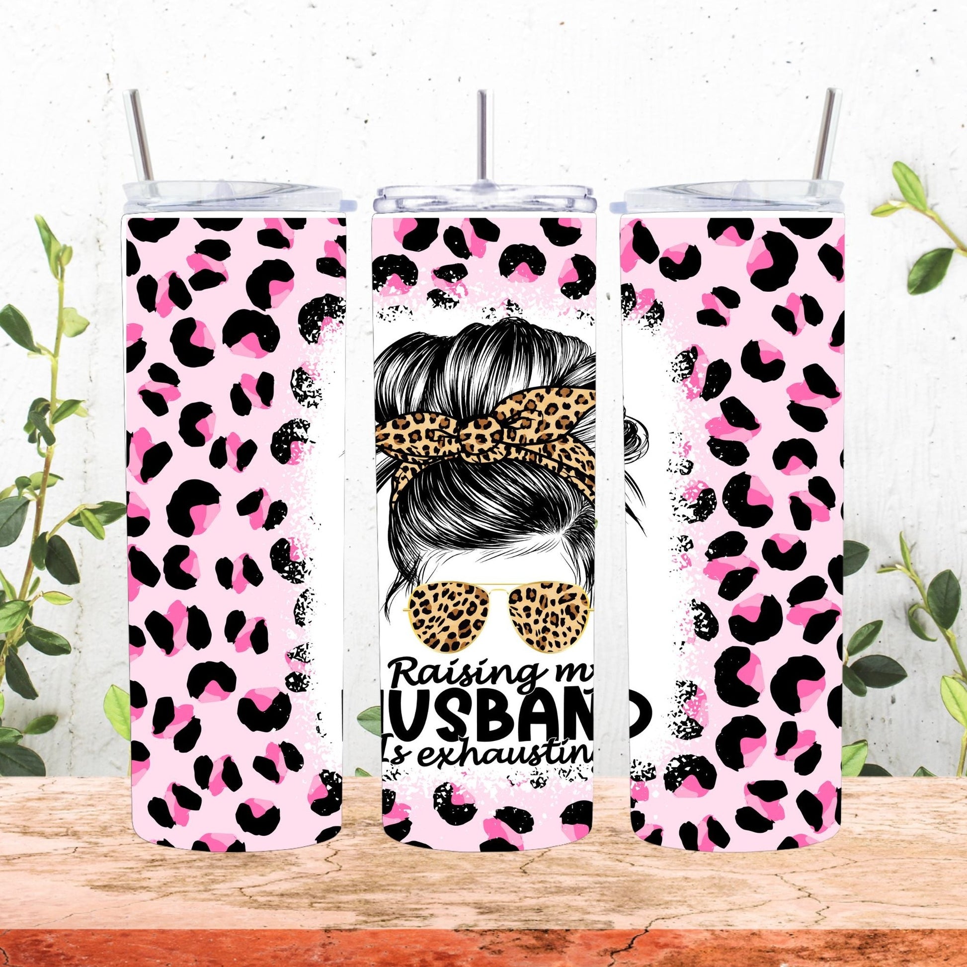 pink and black cheetah design with a messy bun lady tumbler that says raising my husband is exhausting