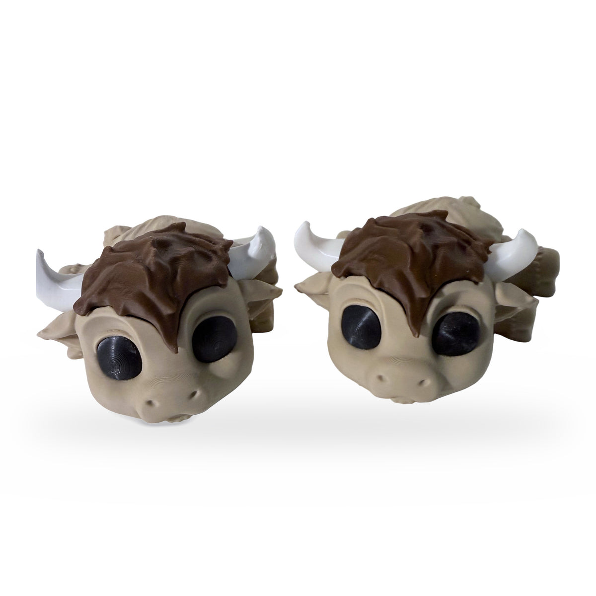 Two 3D printed highland cow flexi toys