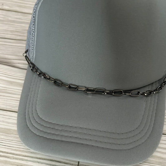 Gun metal trucker hat chain on a grey hat