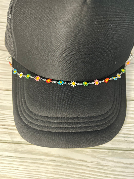 Multi colored daisy trucker hat chain on a black hat