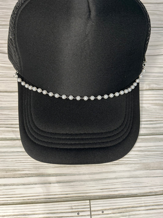 Pearl trucker hat chain on a black hat