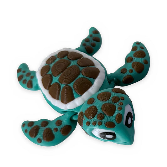 Teal flexi sea turtle fidget toy, top view